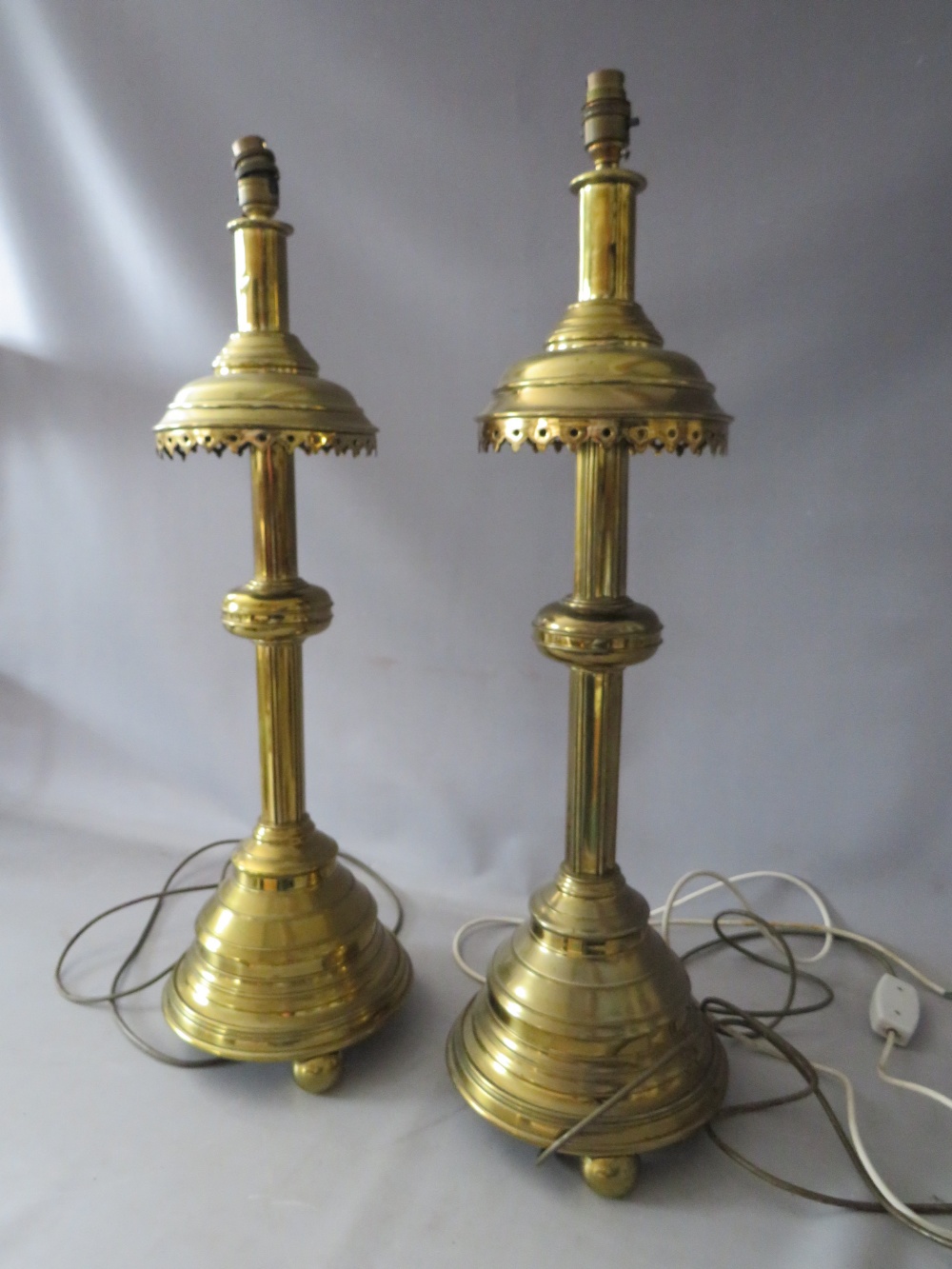 A PAIR OF EARLY 20TH CENTURY HEAVY BRASS ECCLESIASTICAL STYLE CANDLE STANDS CONVERTED TO TABLE - Image 2 of 3