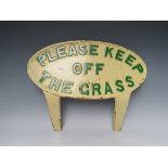 A VINTAGE HEAVY CAST METAL 'PLEASE KEEP OF THE GRASS' PAINTED SIGN, oval form with two struts for