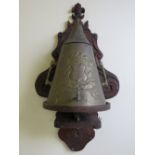 AN UNUSUAL FRENCH METAL URN STAMPED 'JEAN PIED DE PORT', on fitted wooden wall mounted stand, urn