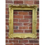 A 19TH CENTURY RECTANGULAR GILT WOOD FRAME, scrolling carved foliate detail throughout, rebate 54