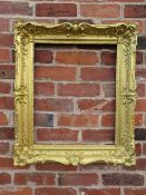 A 19TH CENTURY RECTANGULAR GILT WOOD FRAME, scrolling carved foliate detail throughout, rebate 54