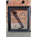 A LARGE LATE 19TH / EARLY 20TH CENTURY EBONISED DUTCH RIPPLE FRAME, frame W 10 cm, rebate 78 x 65