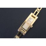 A LADIES RECTANGULAR GOLD EFFECT GUCCI WRIST WATCH, together with spare movement housing, W 1.25 cm