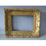 A 19TH CENTURY DECORATIVE GOLD FRAME A/F, frame W 8 cm, rebate 26 x 35 cm