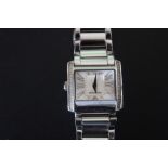 A LADIES GIORGIO ARMANI STAINLESS STEEL WRISTWATCH, with spare link, W 2.75 cm
