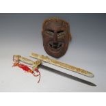 A CHINESE YAO MINORITY TRIBAL WOODEN FACE MASK, H 21 cm, together with a modern Chinese sword, L