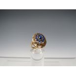 A HALLMARKED 9CT GOLD DRESS RING SET, set with a central oval blue stone and surrounded by ten