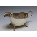 A HALLMARKED SILVER SAUCE BOAT - BIRMINGHAM 1937, makers mark indistinct, on four pad feet, approx