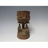 A 19TH CENTURY BLACK FOREST CARVED WOODEN GOBLET, modelled as a lady and gentlemen seated beneath