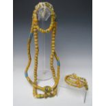 TWO LARGE AFRICAN GLASS TRADE BEAD NECKLACES. together with three similar bracelets. longest L 92 cm