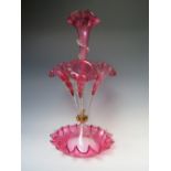 A VICTORIAN CRANBERRY GLASS EPERGNE, with central cranberry flower holder, three further flower