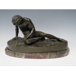 A 19TH CENTURY BRONZE STUDY OF A NAKED MAN 'THE DYING GAUL', rested on an oval base, raised