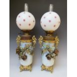 A PAIR OF LATE 19TH CENTURY ORIENTAL STYLE OIL LAMPS, having glazed ceramic bodies, brass