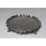 A HALLMARKED SILVER CARD TRAY - BIRMINGHAM 1956, with ball and claw feet and a pie crust border,