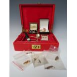 A RED JEWELLERY BOX AND CONTENTS, to include a selection of gold and yellow metal earrings, a