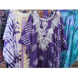 A COLLECTION OF FOUR PURPLE TONE MID CENTURY & LATER AFRICAN AGBADA KAFTAN ROBES, comprising a sate