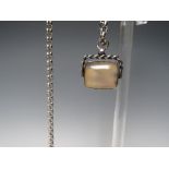 A HALLMARKED SILVER 'SPINNING' FOB WITH POLISHED AGATE PANELS TO BOTH SIDES, suspended on an
