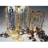 A BASKET OF AFRICAN SHELL AND WOODEN BEAD NECKLACES, plus seed and nut examples, together with a