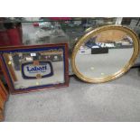 A LABATT ADVERTISING MIRROR AND AN OVAL GILT MIRROR (2)