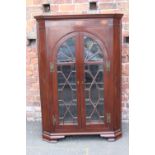 A 19TH CENTURY GLAZED FLOORSTANDING CORNER CABINET, having inlaid satinwood detail to the frieze,