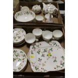 A WEDGWOOD WILD STRAWBERRY SIX PERSON TEASET, FRUIT BOWL ETC CONTAINED IN TWO TRAYS