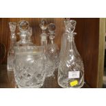 A QUANTITY OF CUT GLASS DECANTERS ETC