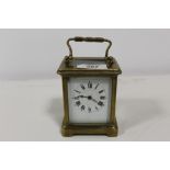 A SMALL BRASS CASED CARRIAGE CLOCK S/D - WITH KEY