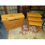 A RETRO TEAK NEST OF TABLES AND A TREASURE CHEST (2)