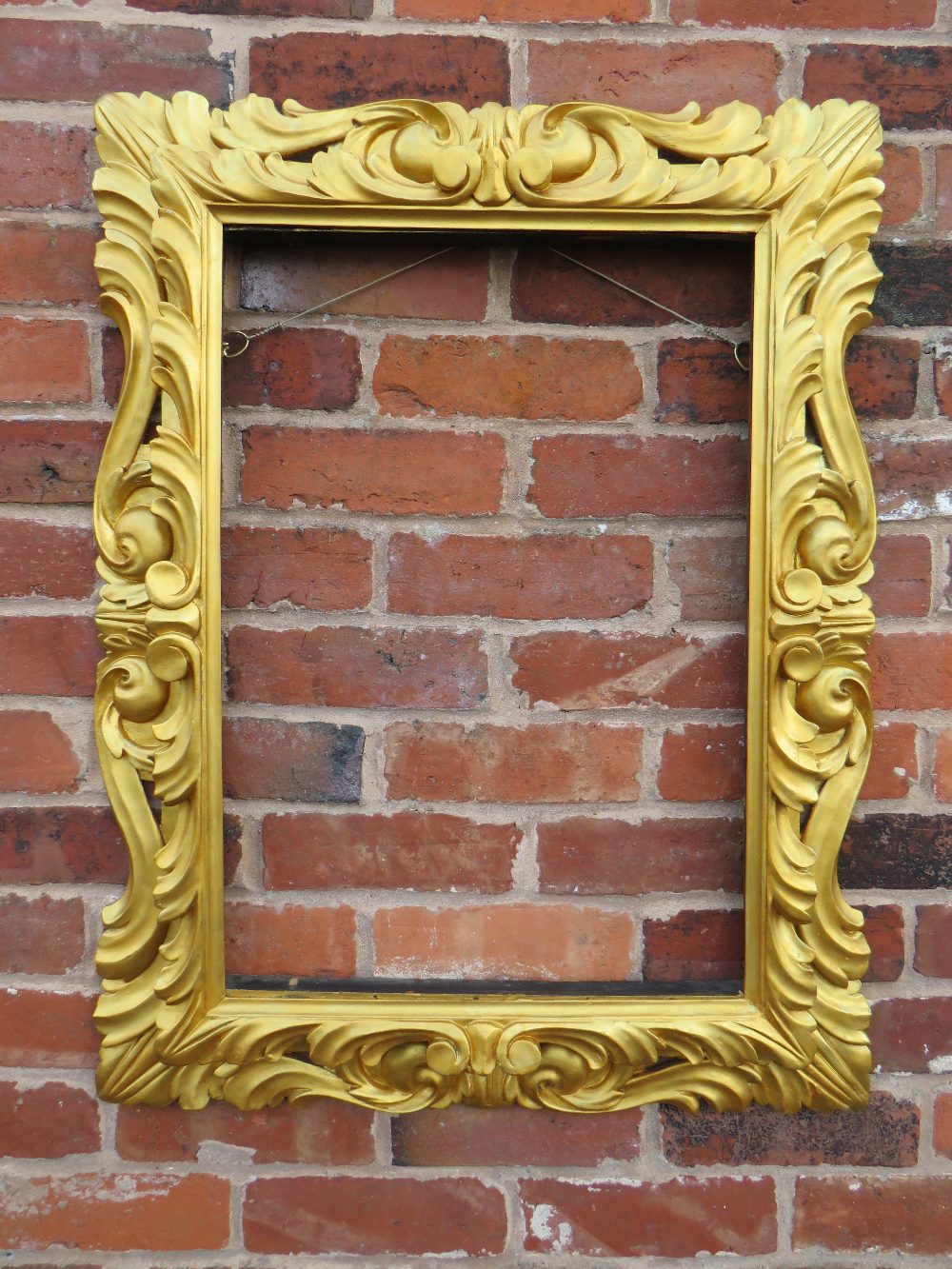 AN EARLY 19TH CENTURY RECTANGULAR GILT WOOD FRAME, in the Florentine style, pierced detail to the