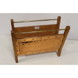 A VINTAGE COPPER AND WOOD MAGAZINE RACK