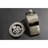 A SILVER SERVICES RENDERED WOUND BADGE AND WHISTLE