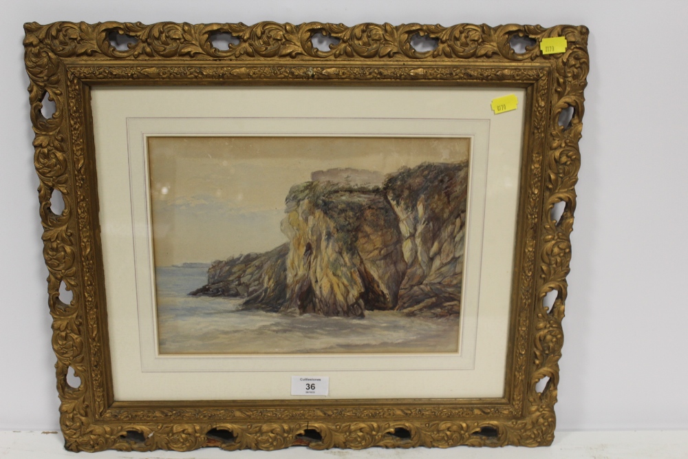 A FRAMED AND GLAZED WATERCOLOUR OF A ROCKY COASTAL SCENE IN A PIERCED GILT FRAME