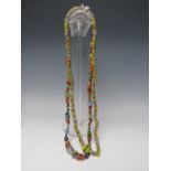AN AFRICAN MILLEFIORE GLASS TRADE BEAD NECKLACE, L 93 cm, together with another similar necklace (