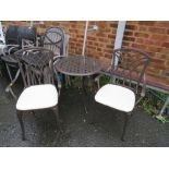 A METAL GARDEN BISTRO TABLE AND TWO ARMCHAIRS WITH PADS