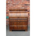 A 19TH CENTURY BIEDERMEIER STYLE MAHOGANY CYLINDER BUREAU HAVING A FITTED INTERIOR, the pull-out