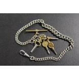 AN ANTIQUE WHITE METAL ALBERT WATCH CHAIN AND 4 POCKET WATCH KEYS