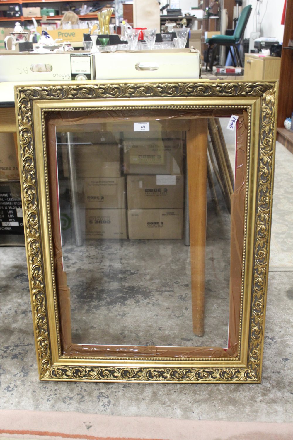 A GILT FRAME WITH GLASS