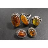 THREE MODERN AMBER RINGS TOGETHER WITH A PAIR OF EARRINGS