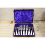 A CASED SET OF MOTHER OF PEARL HANDLED DESSERT KNIVES AND FORKS