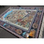A LARGE MODERN EASTERN SILK RUG DECORATED WITH A MOUNTAINOUS HUNTING SCENE 250 X 360