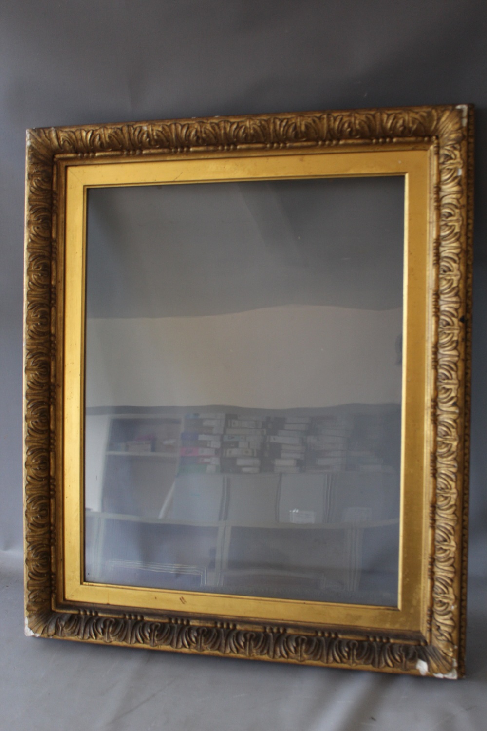 A 19TH CENTURY GOLD FRAME WITH DECORATIVE DESIGN TO OUTER EDGE AND GOLD SLIP, glazed, frame W 6.5