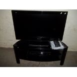 A PANASONIC TV TOGETHER WITH STAND AND A DVD PLAYER