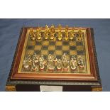 A METAL CHESS SET IN FITTED CASE