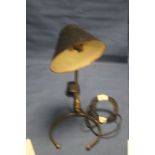 AN UNUSUAL VINTAGE COMBINATION TABLE LAMP/ WALL LIGHT WITH PAINTED METAL SHADE AND BRASS BASE