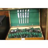 AN OAK CASED CANTEEN OF STAINLESS STEEL CUTLERY