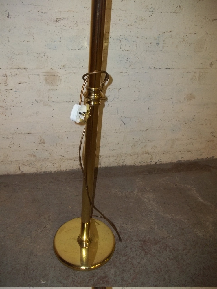 A BRASS FLOOR STANDING STANDARD LAMP