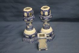 A PAIR OF BLUE AND WHITE CANDLE HOLDERS TOGETHER WITH ANOTHER