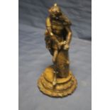 A HEAVY BRASS FIGURE