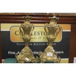 A PAIR OF CONTINENTAL STYLE GILT METAL CANDLE STICKS