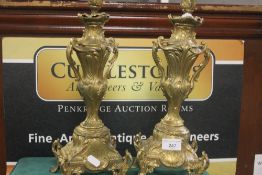 A PAIR OF CONTINENTAL STYLE GILT METAL CANDLE STICKS